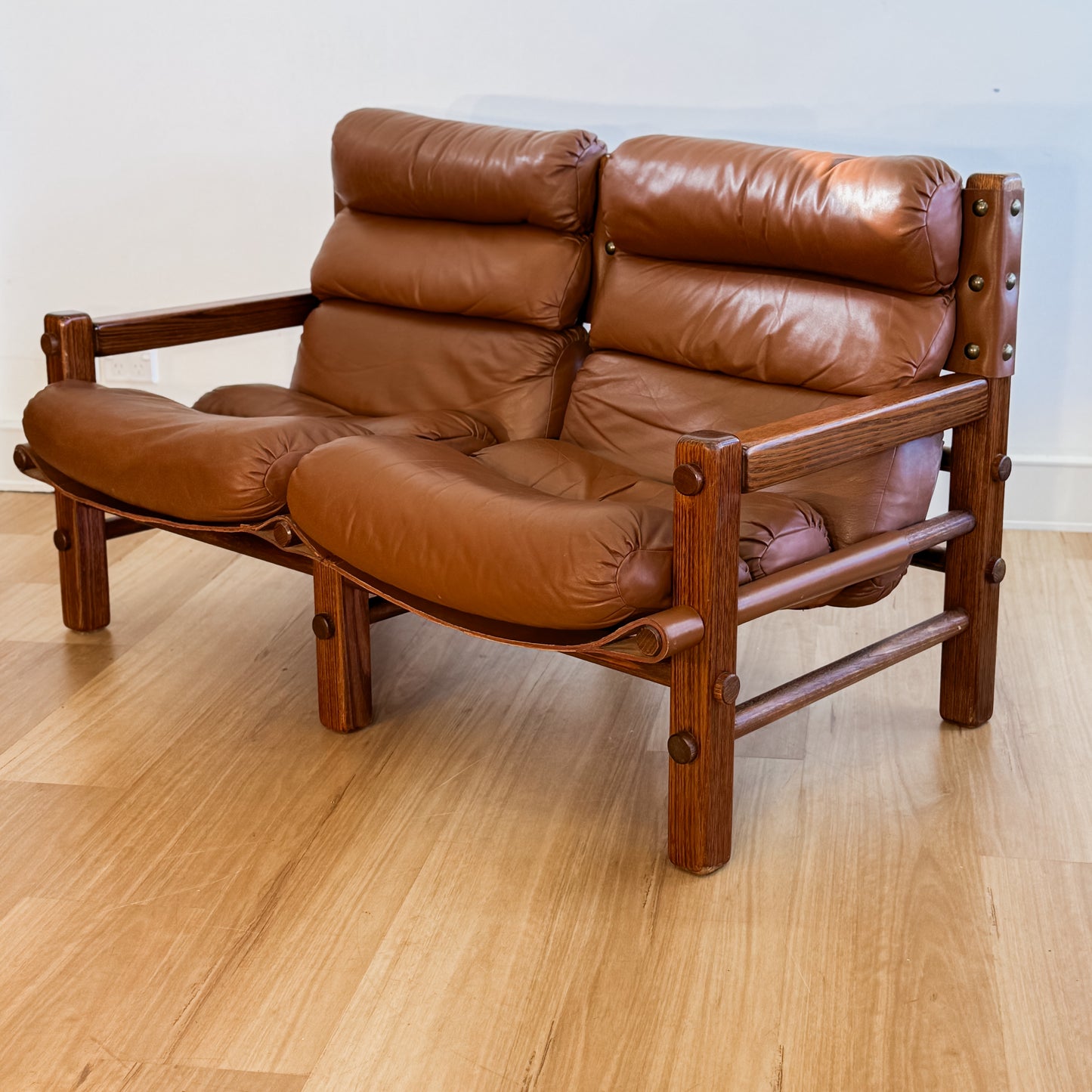 Norman Archibald 1970s ‘Nore’ vintage two seater leather sofa