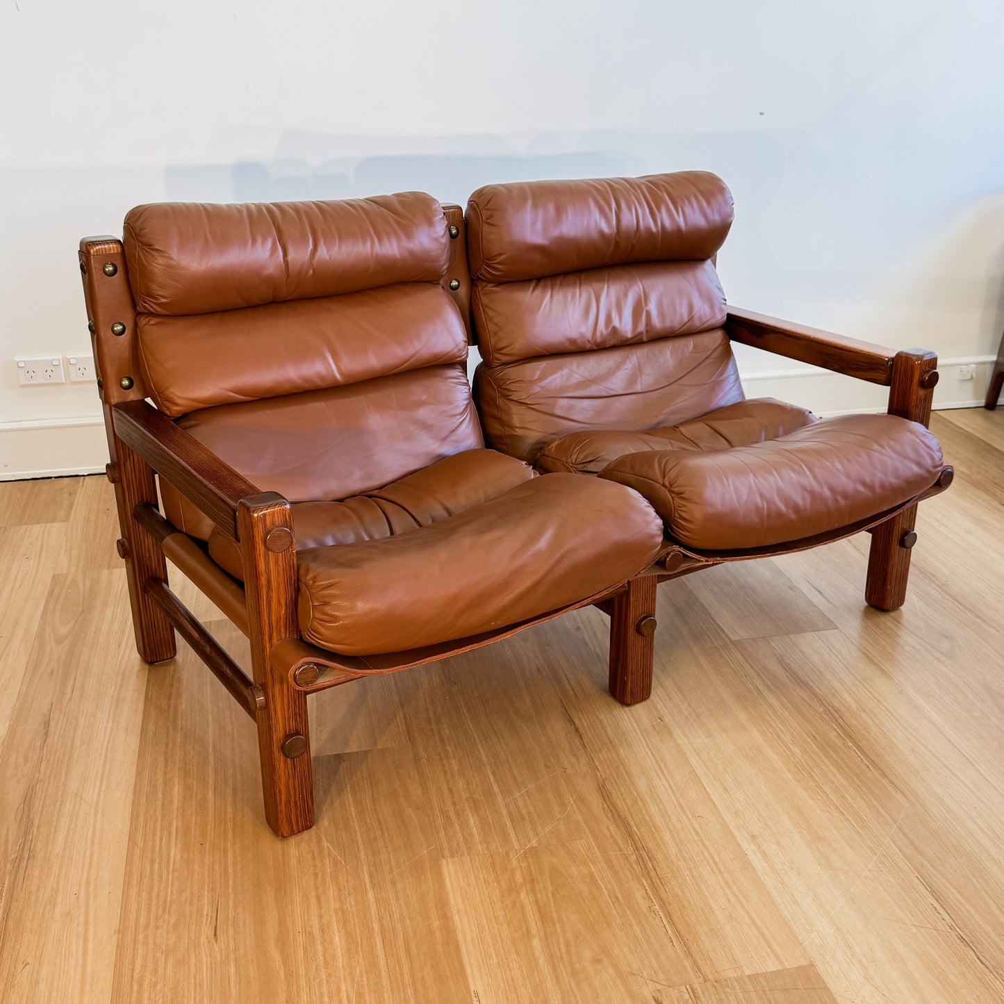 Norman Archibald 1970s ‘Nore’ vintage two seater leather sofa