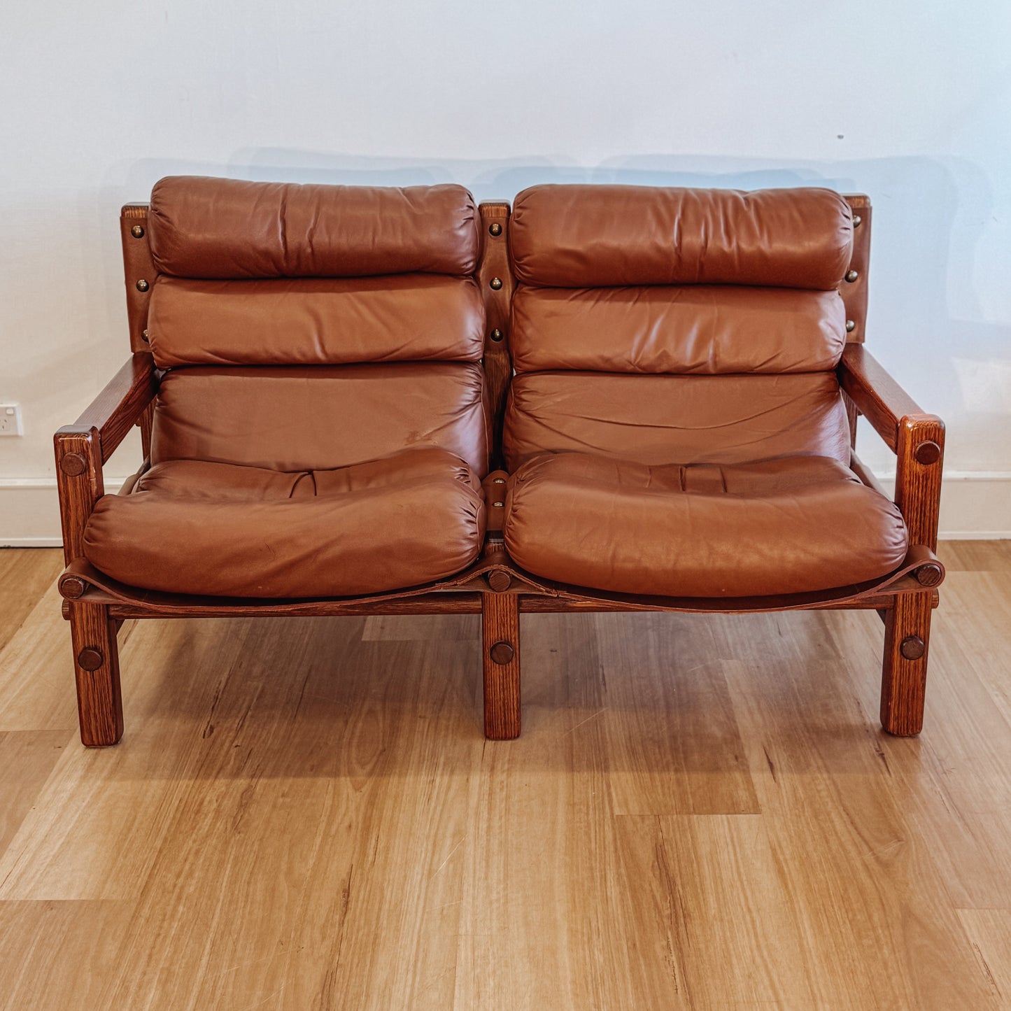 Norman Archibald 1970s ‘Nore’ vintage two seater leather sofa