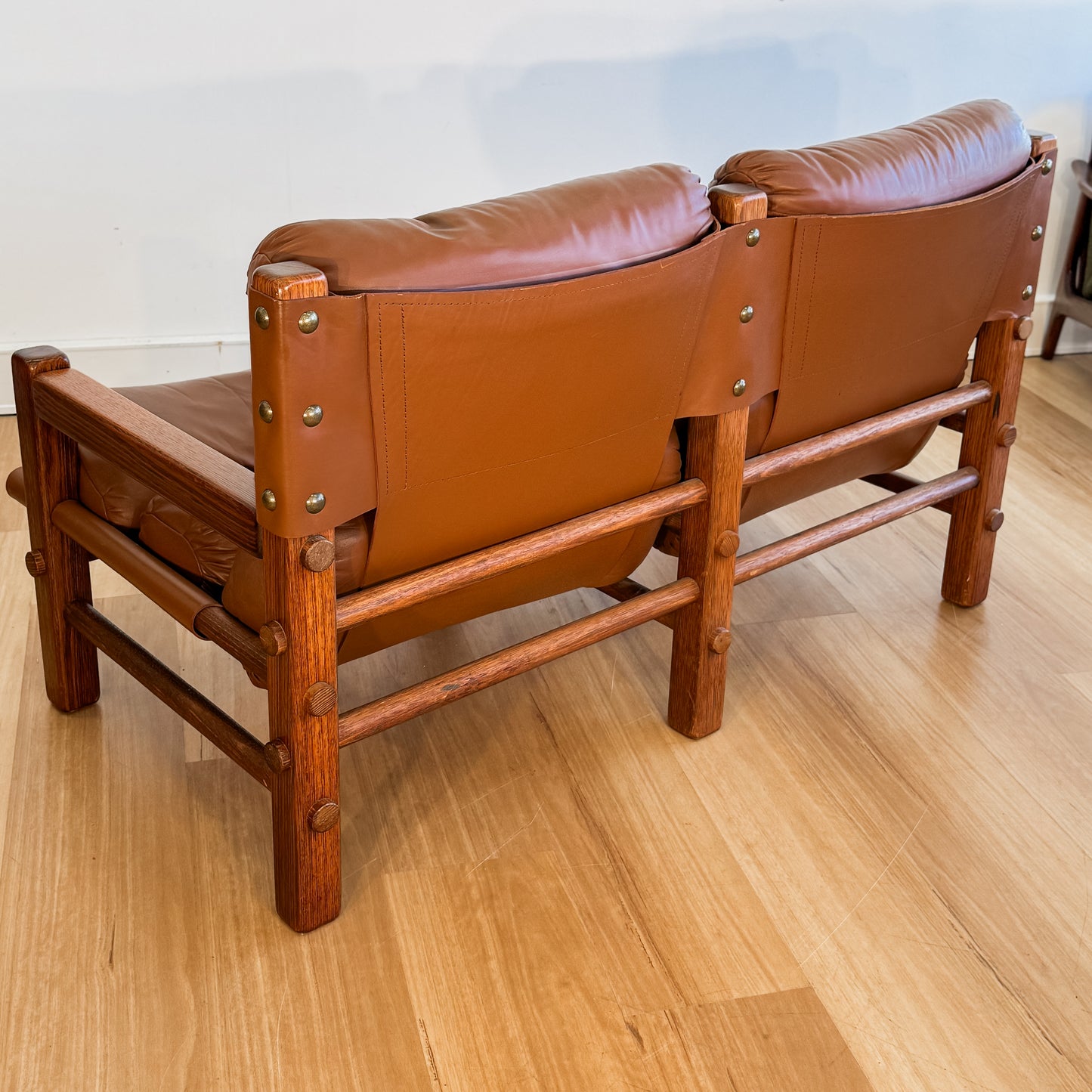 Norman Archibald 1970s ‘Nore’ vintage two seater leather sofa