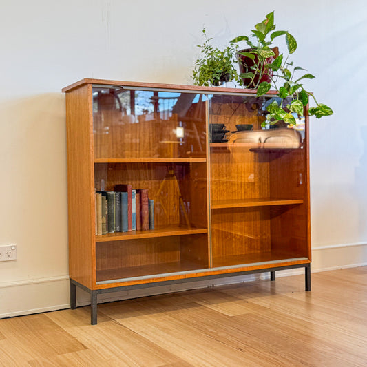 Circa 1970s veneer bookshelf with glass sliding door