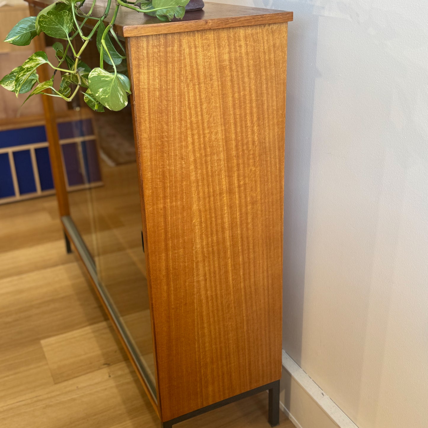 Circa 1970s veneer bookshelf with glass sliding door