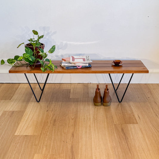 A timber coffee table, with minimalist metal legs