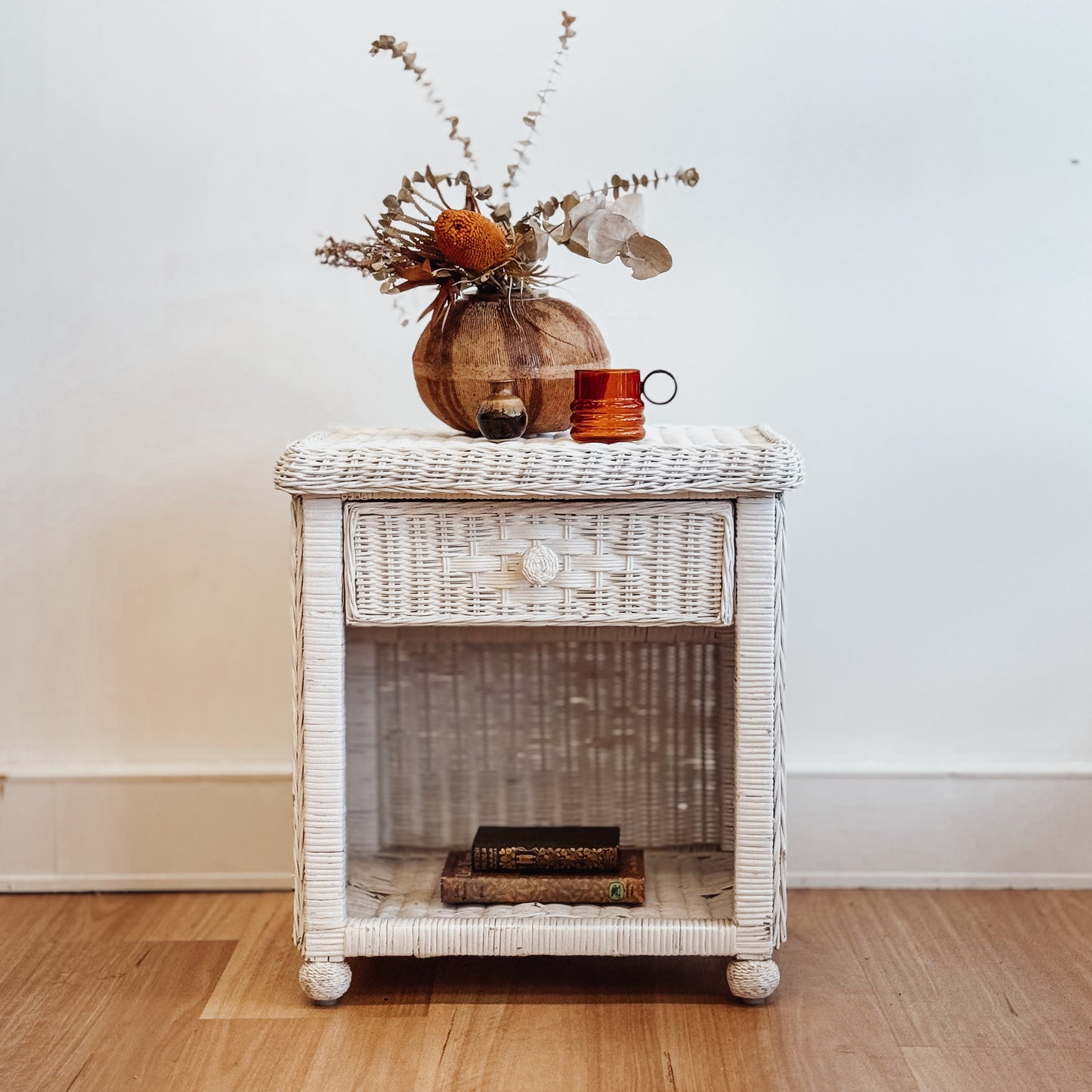 Vintage white painted cane bedside table