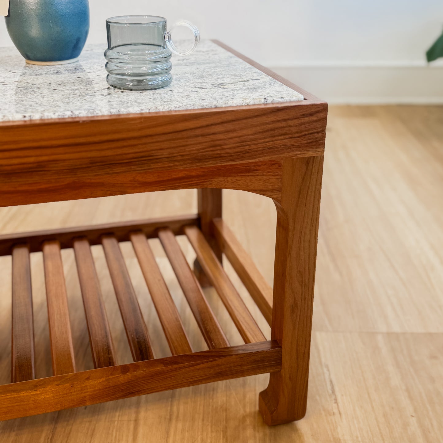 Stone top coffee table with slatted shelf underneath
