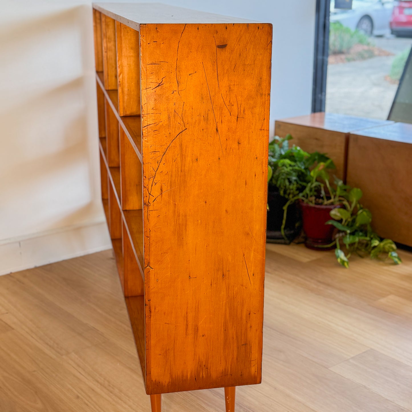Mid century pigeonhole bookshelf on cigar legs
