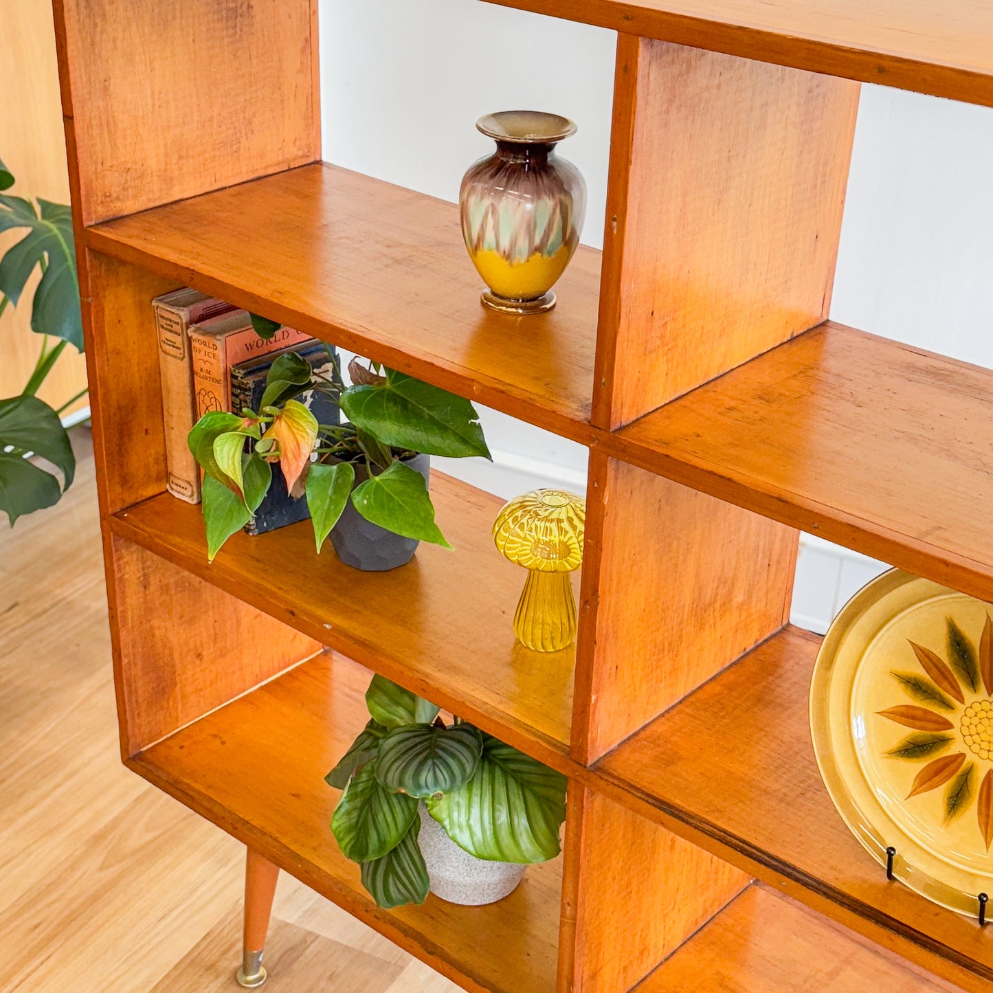 Mid century pigeonhole bookshelf on cigar legs