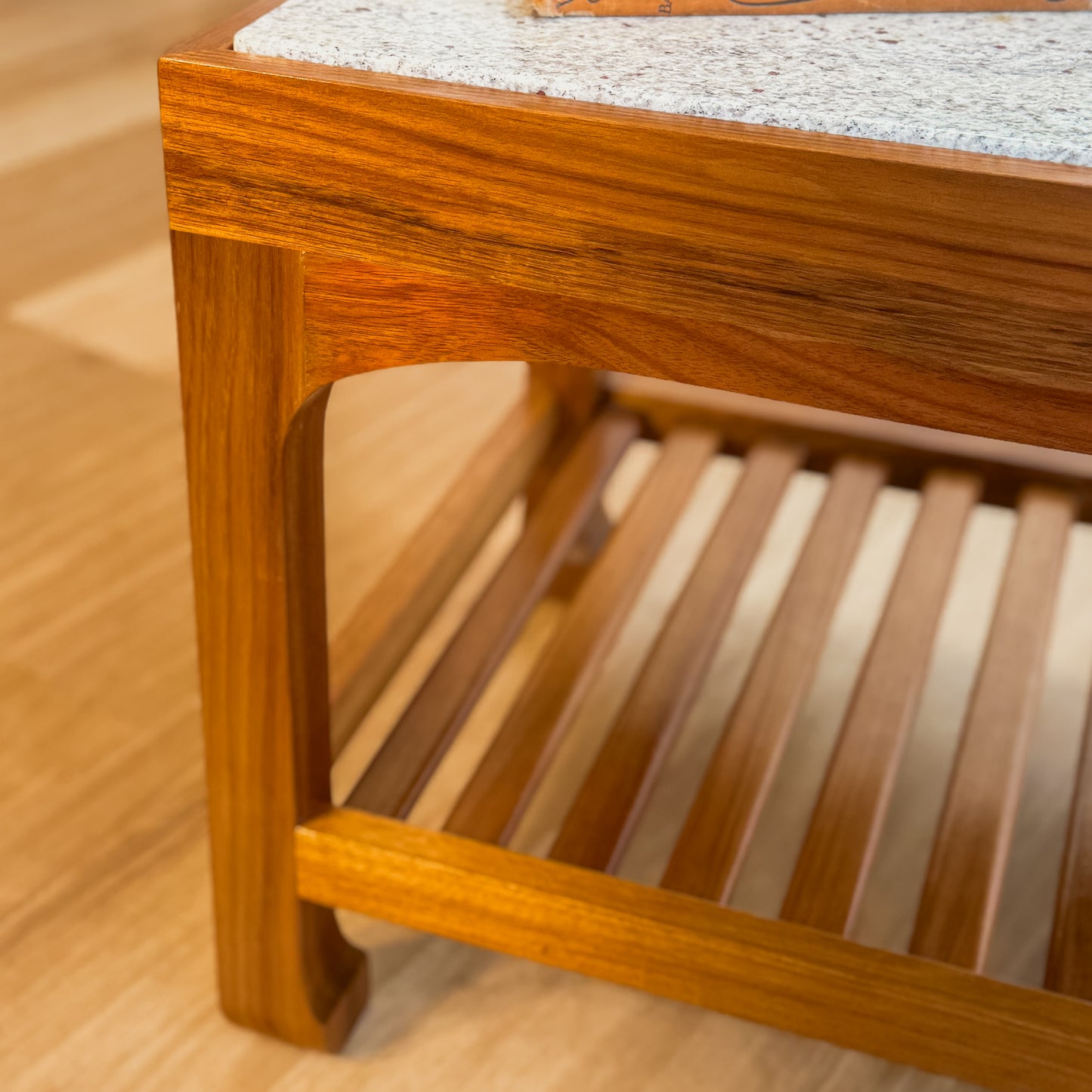 Stone top coffee table with slatted shelf underneath