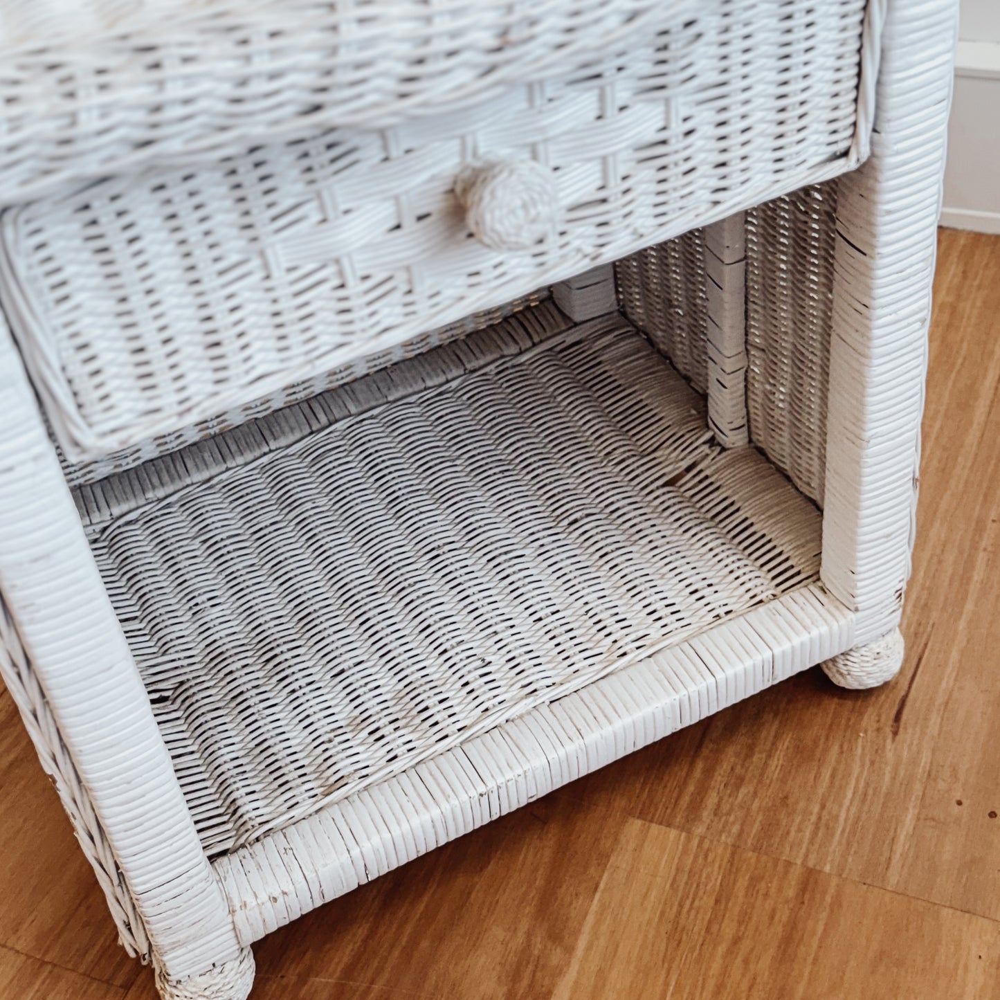 Vintage white painted cane bedside table