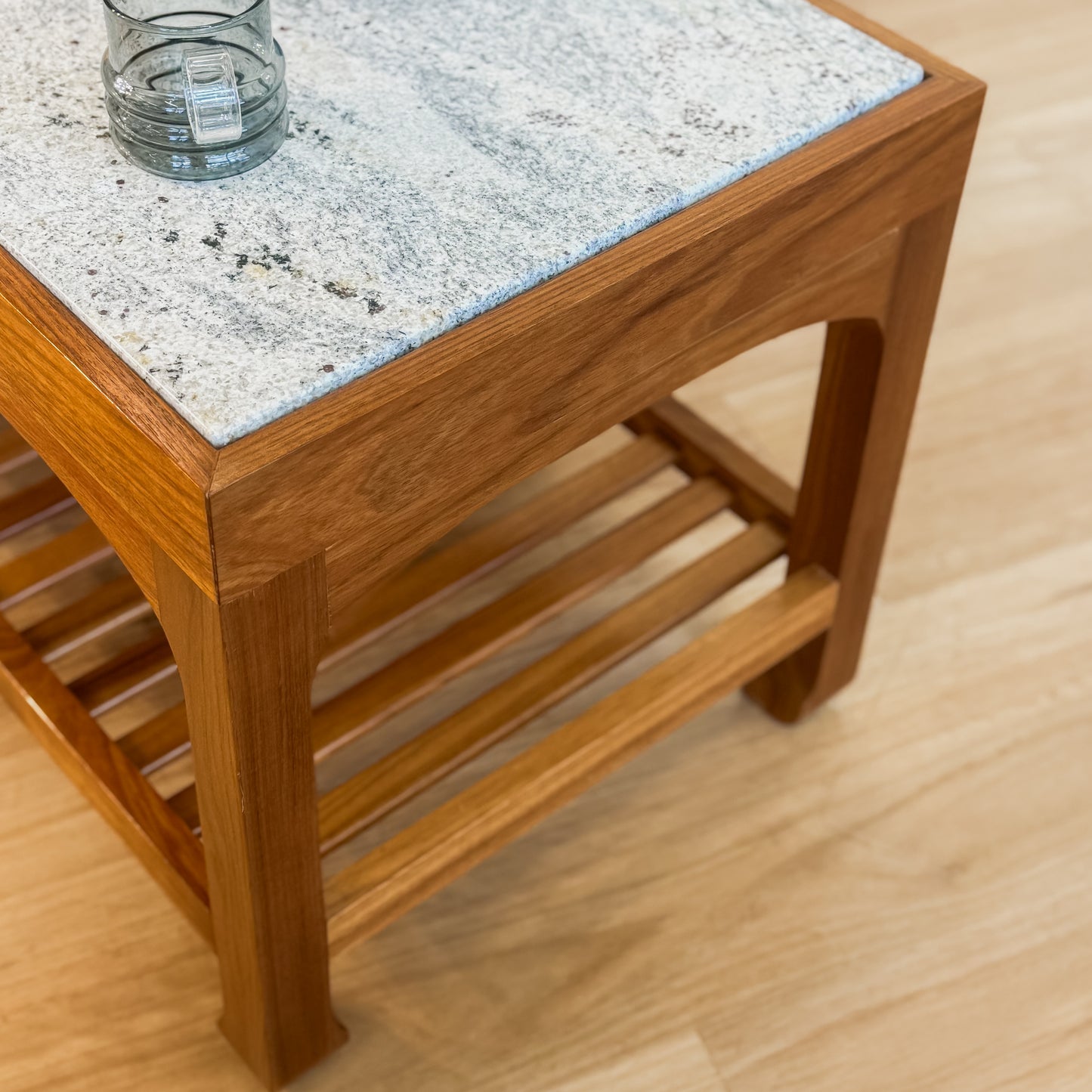 Stone top coffee table with slatted shelf underneath