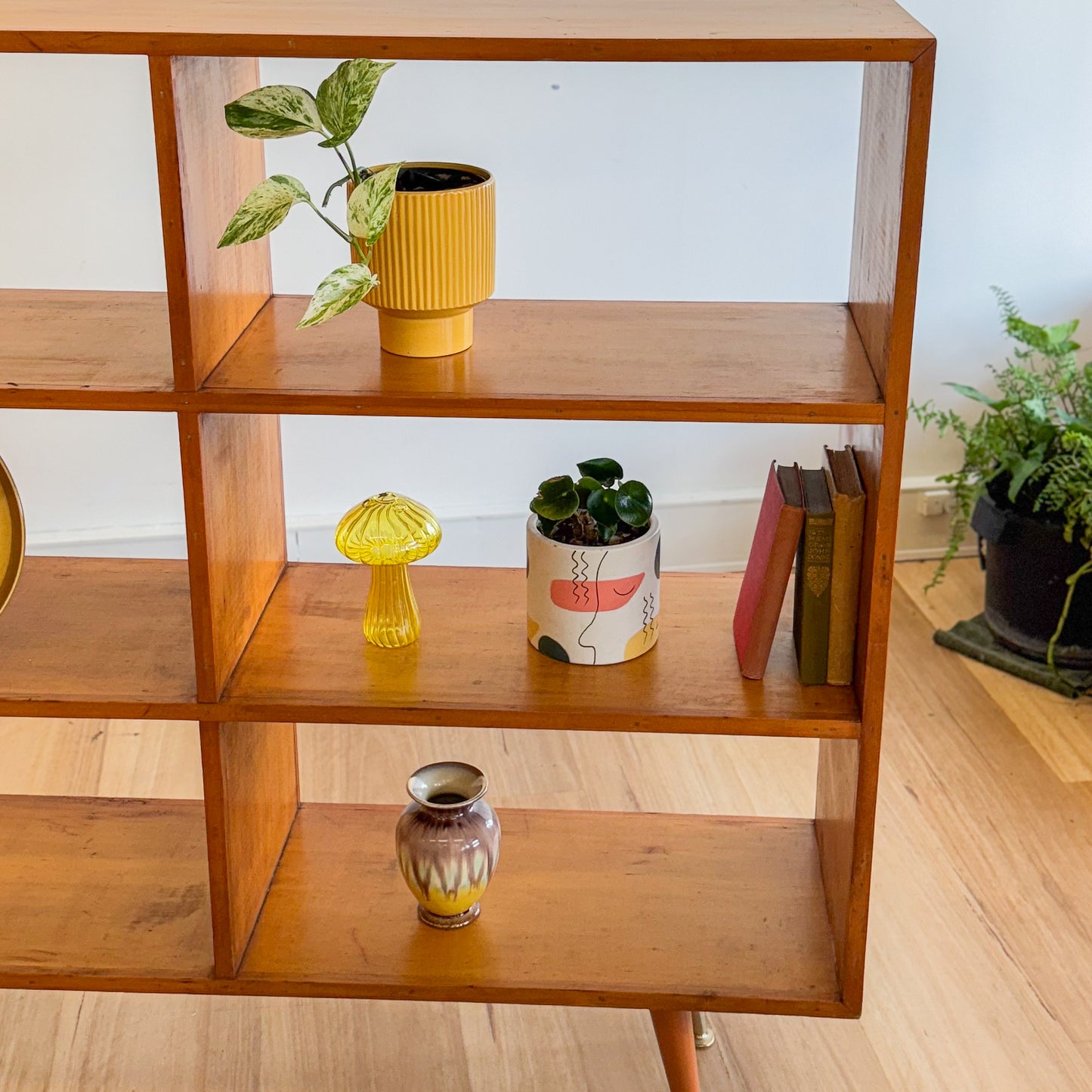 Mid century pigeonhole bookshelf on cigar legs