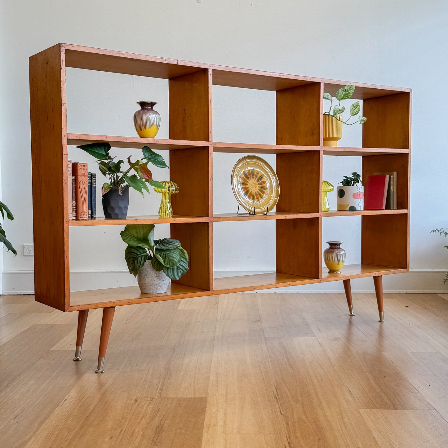 Mid century pigeonhole bookshelf on cigar legs
