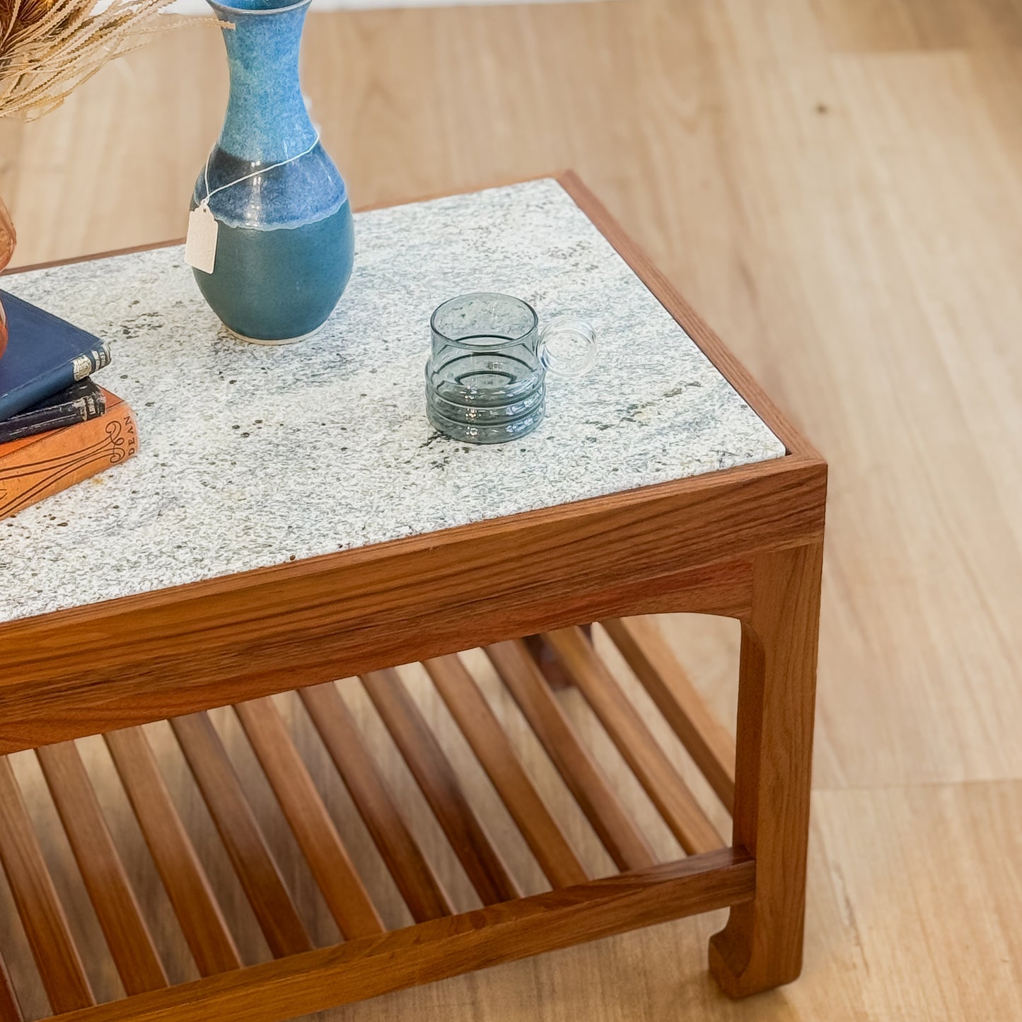Stone top coffee table with slatted shelf underneath