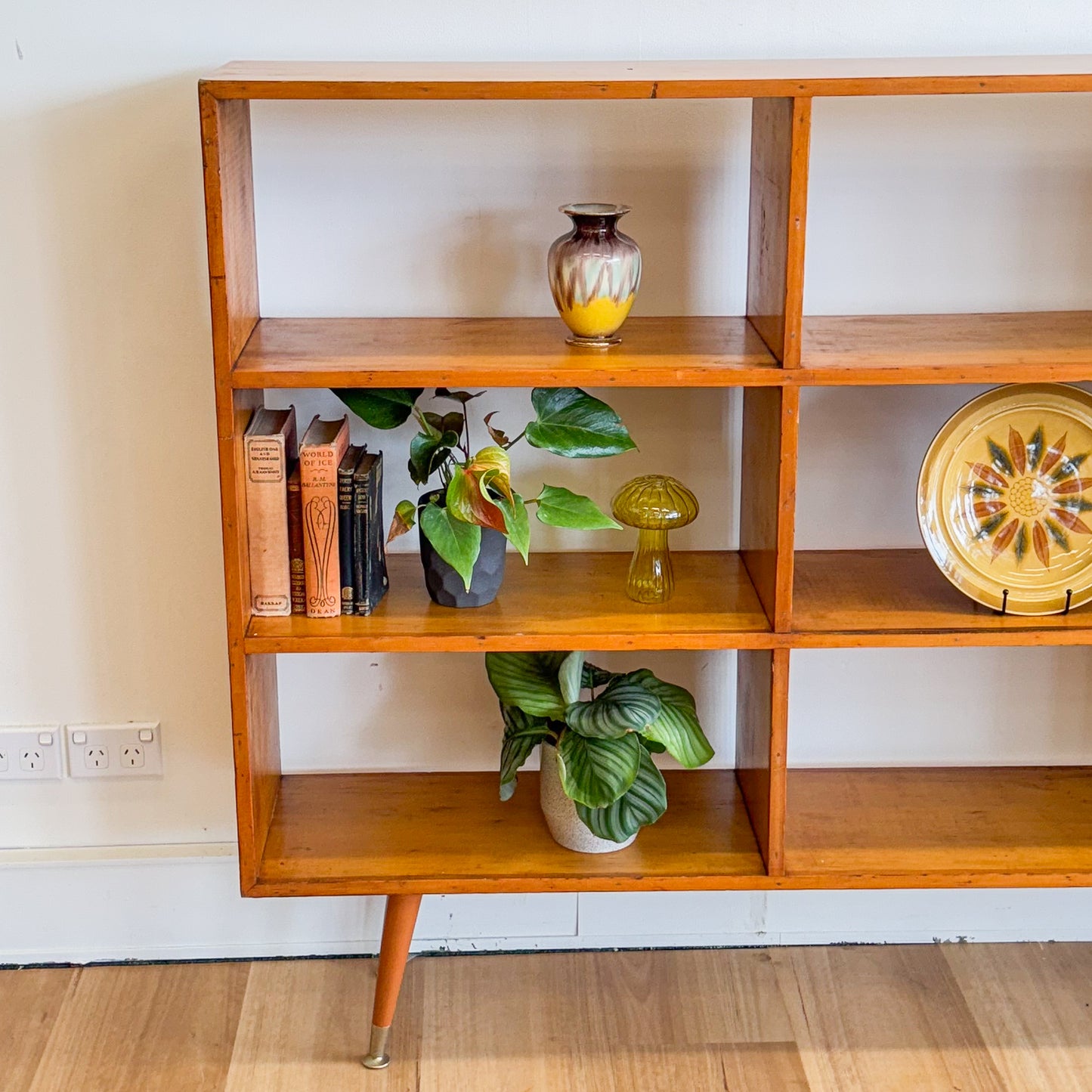 Mid century pigeonhole bookshelf on cigar legs