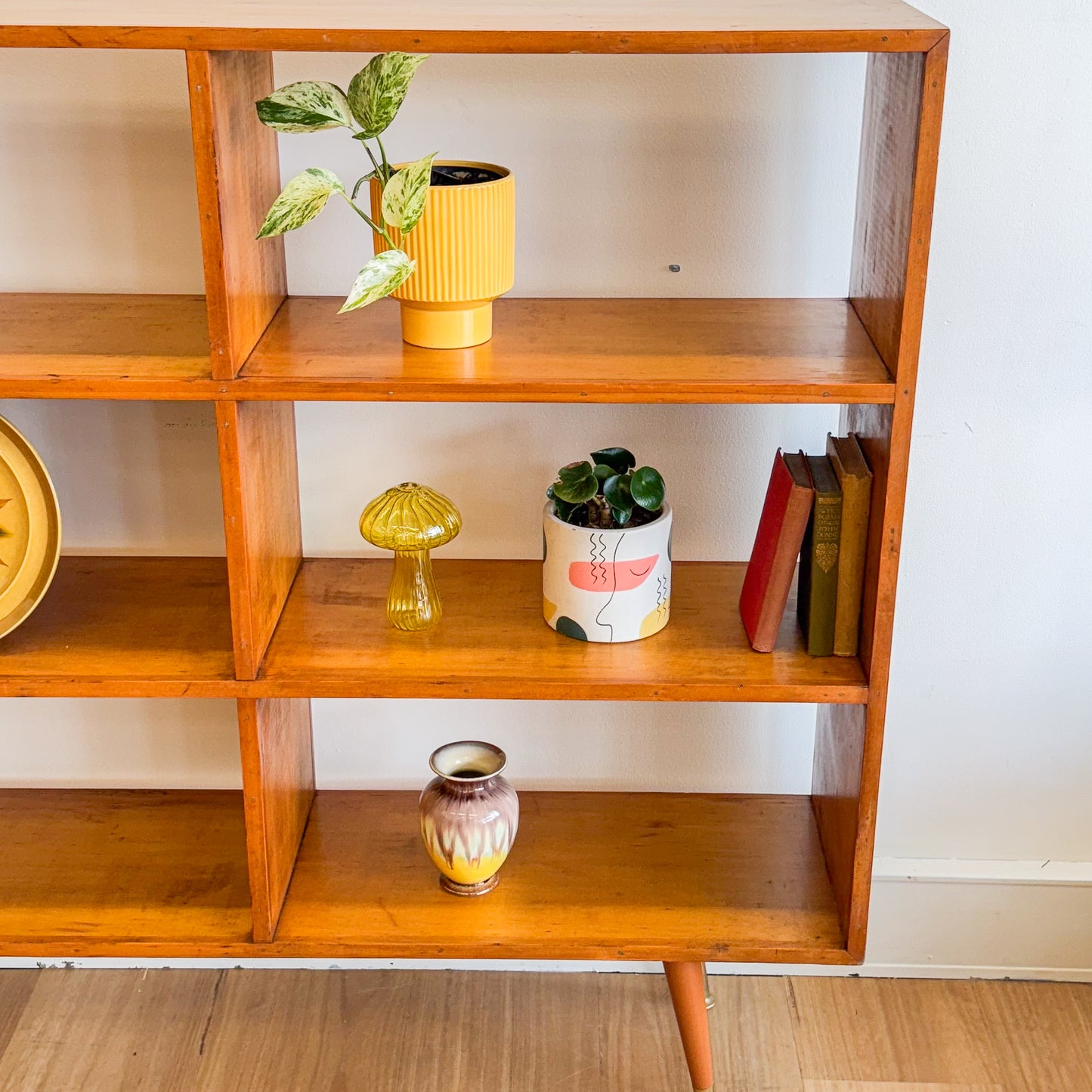 Mid century pigeonhole bookshelf on cigar legs